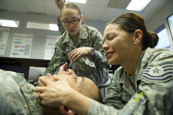 U.S. Air Force Staff Sgt. Claudia Ramirez, 49th Medical Operations Squadron Self Aid and Buddy Care advisor for the 49th Wing, oversees Tech. Sgt. Lisa Alvarado opening the airway of Airman 1st Class Clyde Thomas during a SABC training class March 7 at the 49th Medical Group Education and Training Flight building. All 49th Wing Airmen are required to take the SABC hands-on training class every two years and before any deployments. (U.S. Air Force photo by Airman 1st Class Siuta B. Ika/Released) 

