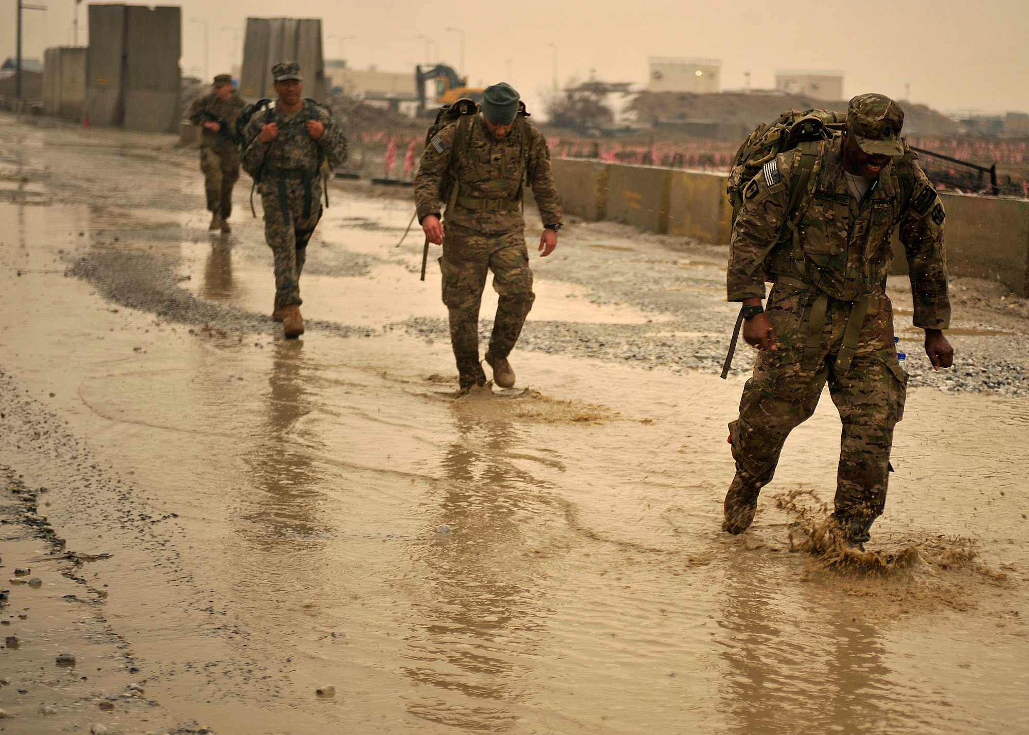 Participants in the Senior Airman Jason Cunningham Remembrance Ruck March trudge along the perimeter of Bagram Airfield, Afghanistan, March 4, 2012. Cunningham was a pararescueman who died in combat March 4, 2002, while saving 10 men’s lives. The Air Force’s Camp Cunningham at Bagram Airfield is named after him. The ruck march was one part of a three-part ceremony held in remembrance of the 10 year anniversary of his heroic sacrifice. (U.S. Air Force photo/Airman 1st Class Ericka Engblom)
