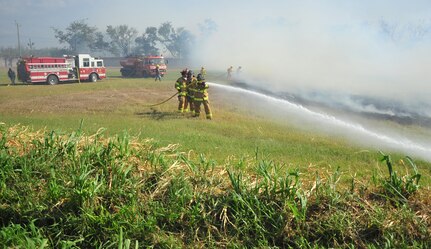 SOTO CANO AB, Honduras - Firefighters from the Joint Task Force-Bravo and Comayagua fire departments work side by side to contain a brushfire which started on Soto Cano AB March 4 here. While both fire departments worked to contain the fire on the ground, from above the 1st Battalion, 228th Aviation Regiment dropped water using a U.S. Army CH-47 Chinook and a UH-60 Blackhawk. (U.S. Air Force photo/Staff Sgt. Bryan Franks) 