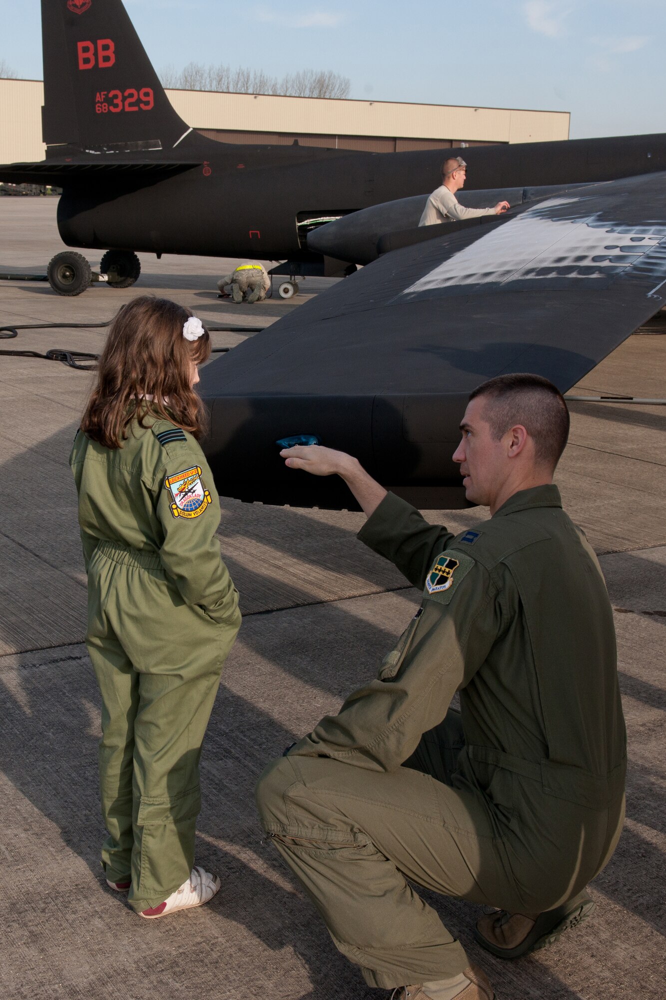 RAF FAIRFORD, United Kingdom - Capt. Mike Gray, 9th Reconnaissance Wing, describes some of the unique characteristics of the U-2 Dragon Lady to Ellie Carter. Ellie, a 9-year-old British schoolgirl, recently wrote a letter to the organizers of the Royal International Air Tattoo about her desire to see a U-2 that caught international media attention. (U.S. Air Force photo by Capt. Brian Maguire)
