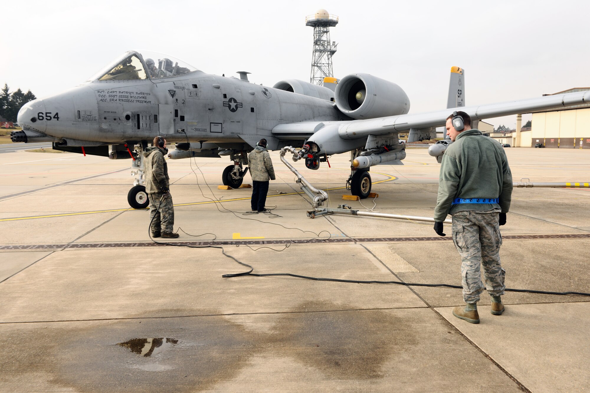 SPANGDAHLEM AIR BASE, Germany – Staff Sgt. Michael Selfridge, right, 52nd Maintenance Operations Squadron aircraft maintenance inspector, inspects the hot-pit refueling of an A-10 Thunderbolt II from the 81st Fighter Squadron ramp three here March 6. The AMXS quality assurance section is made up of eight certified maintenance inspectors who inspect 81st and 480th Fighter Squadron aircraft maintenance processes. Quality assurance modernizes the Air Force’s aircraft maintenance and training by tracking maintenance performance against metrics to improve efficiency, production, and reliability.  (U.S. Air Force photo by Airman 1st Class Dillon Davis/Released)