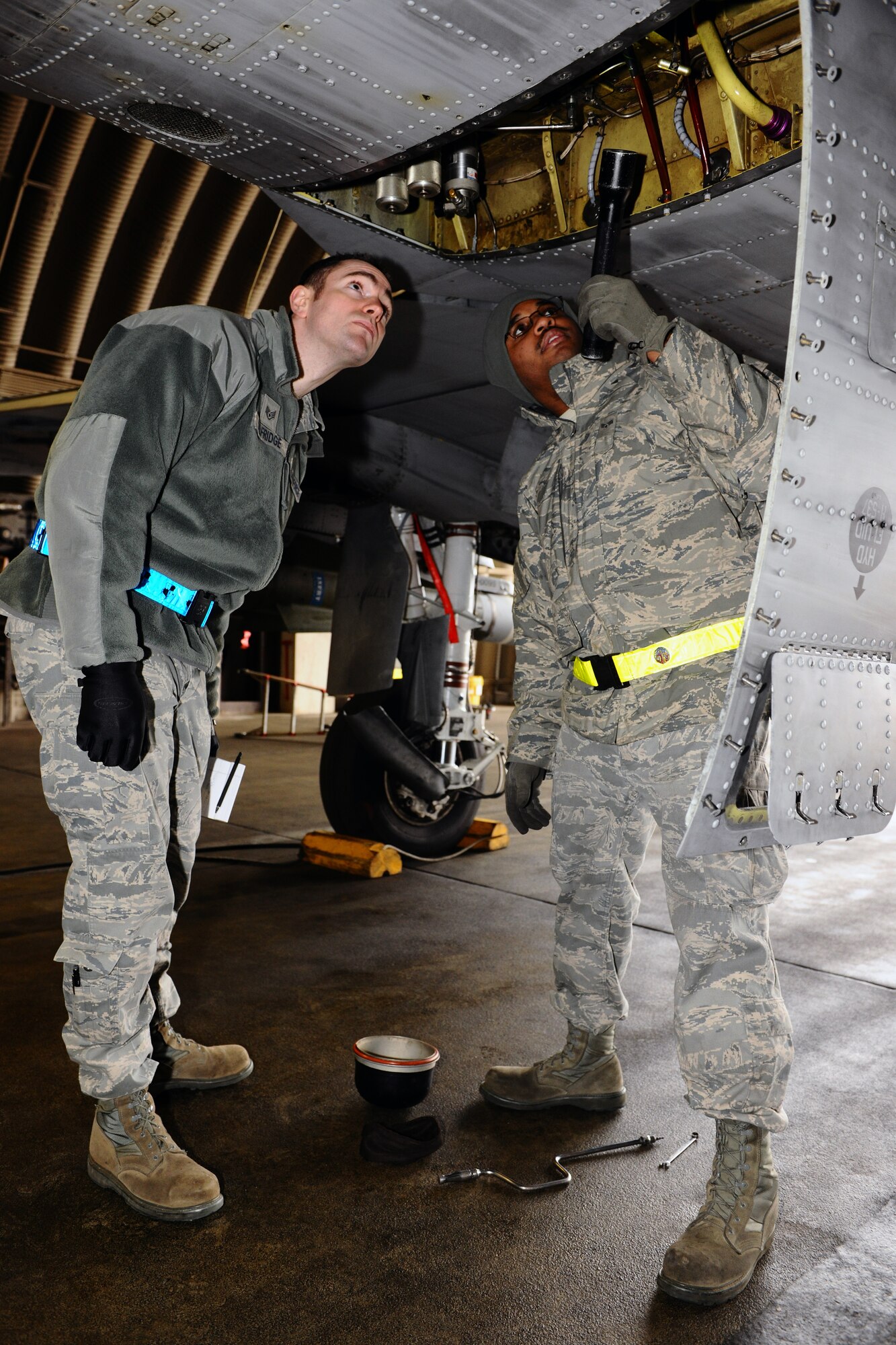 SPANGDAHLEM AIR BASE, Germany – Staff Sgt. Michael Selfridge, left, 52nd Maintenance Operations Squadron aircraft maintenance inspector, inspects Senior Airman William Jones’, 52nd Aircraft Maintenance Squadron environmental electrician journeyman, work while he troubleshoots an environmental control system issue of an A-10 Thunderbolt II inside Hardened Aircraft Shelter 16 here March 6. The AMXS quality assurance section is made up of eight certified maintenance inspectors who inspect 81st and 480th Fighter Squadron aircraft maintenance processes. Quality assurance modernizes the Air Force’s aircraft maintenance and training by tracking maintenance performance against metrics to improve efficiency, production, and reliability.  (U.S. Air Force photo by Airman 1st Class Dillon Davis/Released)