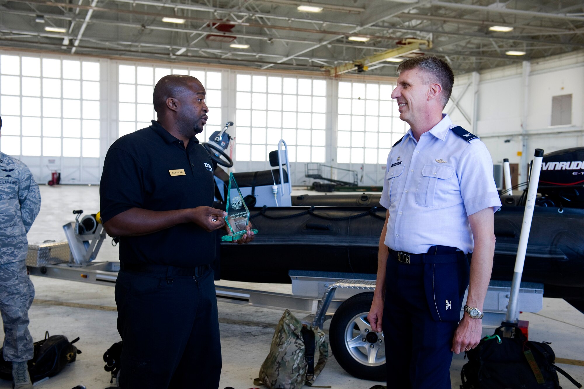 Col. Jeffrey Macrander, 920th Rescue Wing Commander, speaks to the Department of Defense's Executive Leadership Development Program during a tour of the 920th RQW Monday.  The ELDP members, participants in a 10-month immersive program that exposes them to the roles and mission of the entire DOD, visited Cape Canaveral Air Force Station before ending their day learning about the Air Force Reserve's Combat Search and Rescue missions. The class was able to climb on board an HC-130/King aircraft and HH-60G Pave Hawk helicopter to learn about their mission capabilities. Two pararescuemen (PJs) were on scene with their gear to talk about their role during search and rescue missions and their experiences while deployed recently to Afghanistan. (photo by Ms. Julie Dayringer)