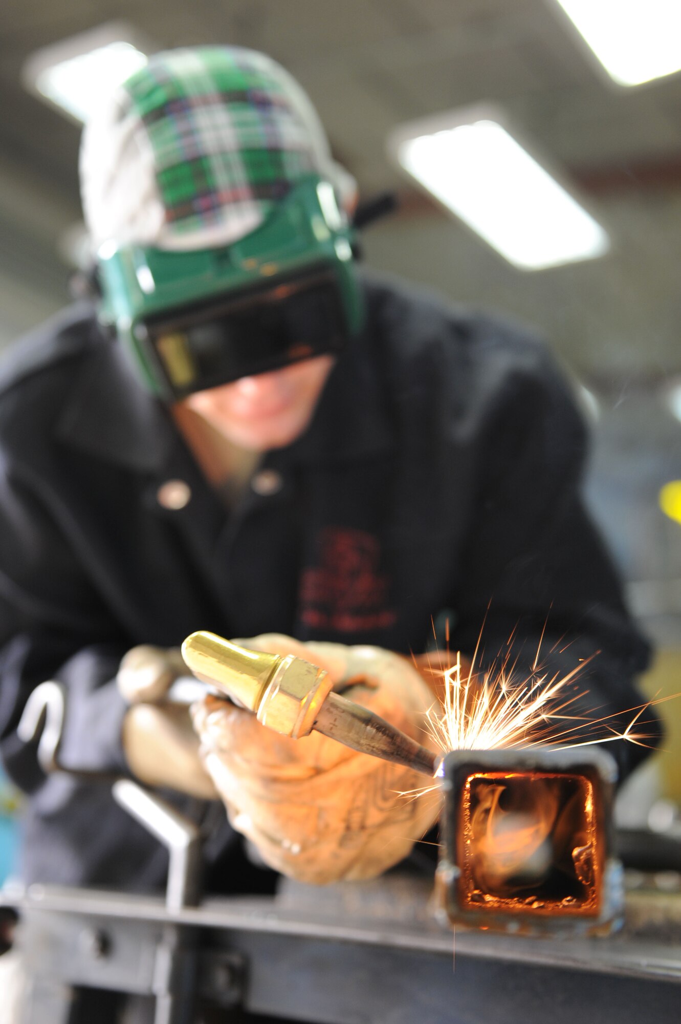 SPANGDAHLEM AIR BASE, Germany – Airman 1st Class Douglas Williams, 52 Equipment Maintenance Squadron aircraft metals technology apprentice, cuts steel for fabrication use at Bldg. 41 here March 7.  The fabrication flight repair aircraft and support equipment fabricate assets that cannot be bought using computer numerical controlled machines and welding equipment. Fabrication keep 51 F-16 and A-10 aircraft repaired, as well as equipment and facilities worth over $992 million ready to provide combat power to the current flight through precise repairs to all assets. (U.S. Air Force photo by Senior Airman Christopher Toon/Released)