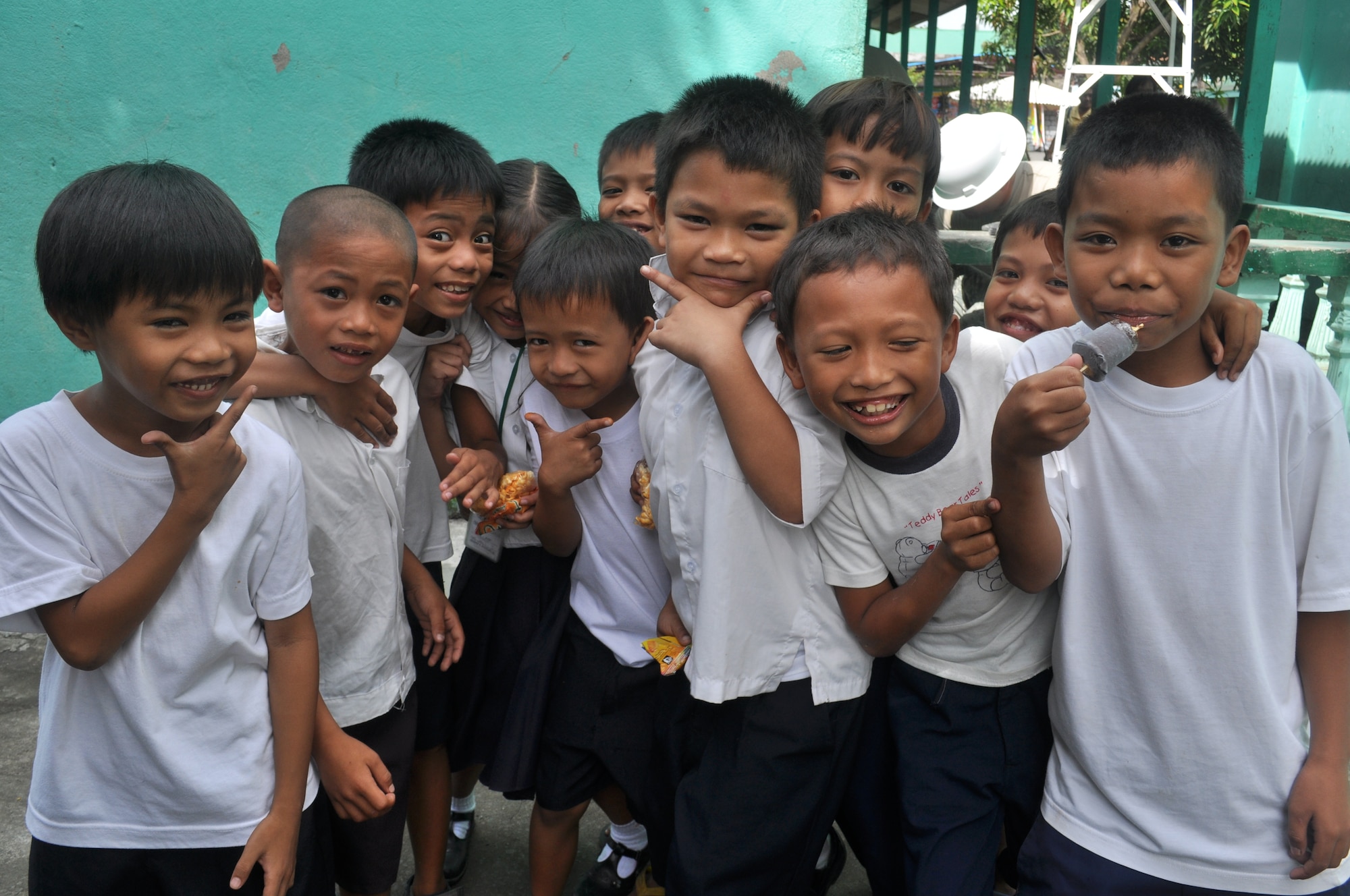 Students from Binitayan Elementary School pose for a photo at their school in Legazpi City, philippines, March 5, 2012 during recess. The students spent time at recess observing U.S. and Philippine engineers who were rebuilding three classrooms during Operation Pacific Angel-Philippines a joint and humanitarian mission which included engineering support to the region. It is scheduled to run through March 10. (U.S. Air Force photo/Master Sgt. Allison Day)