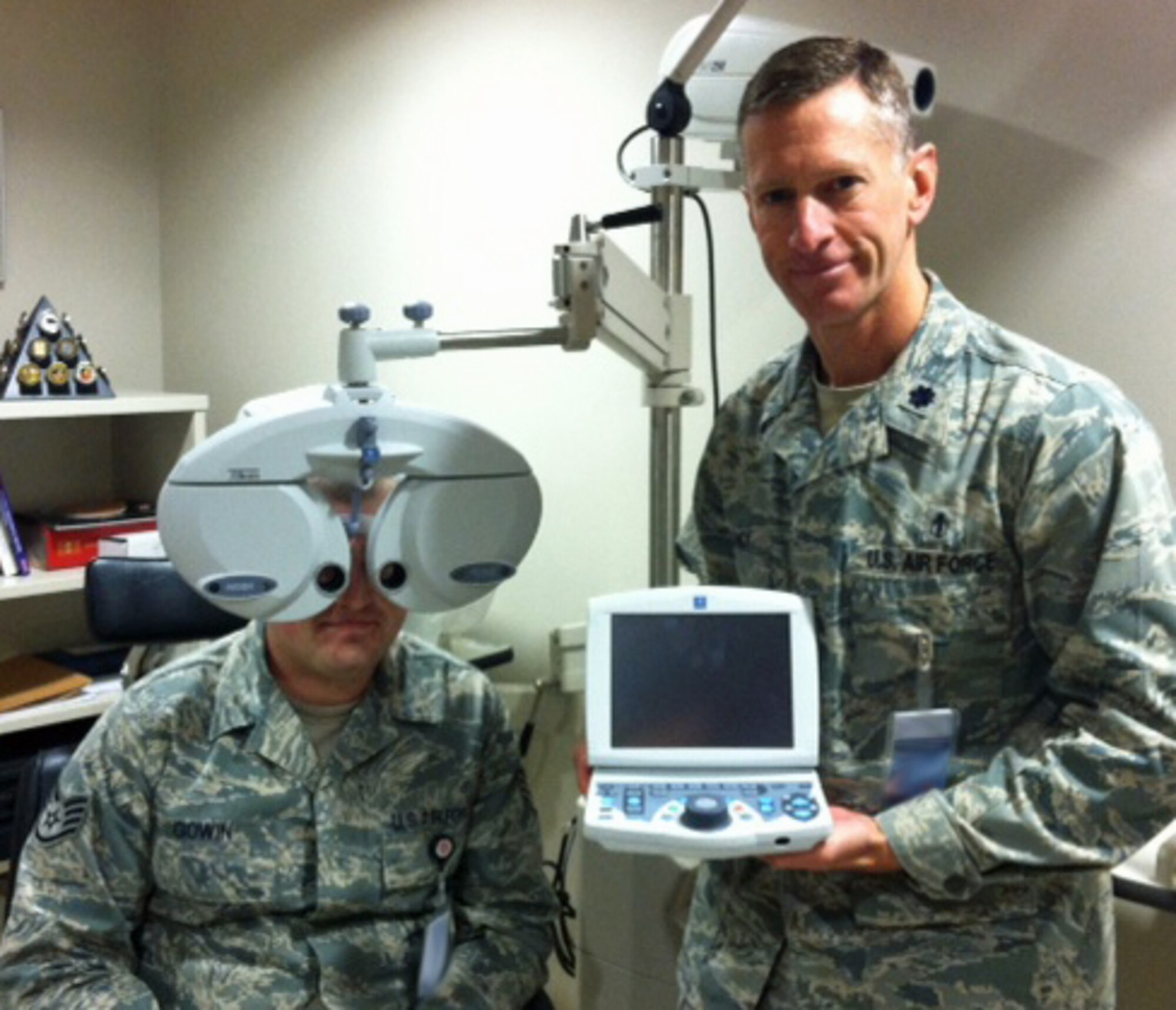 Lt. Col. Steven Clancy, 21st Medical Group Optometry Flight commander, shows off the clinic’s innovative new tool, an automated refraction system, which will allow more efficient patient care. (U.S. Air Force photo)
