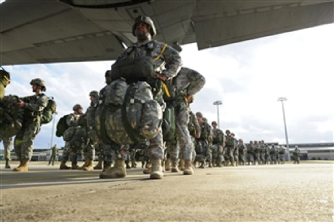 U.S. Army soldiers board a C-130 Hercules aircraft assigned to the 61st Airlift Squadron for a personnel drop at Fort Bragg, N.C., on Feb. 29, 2012.  