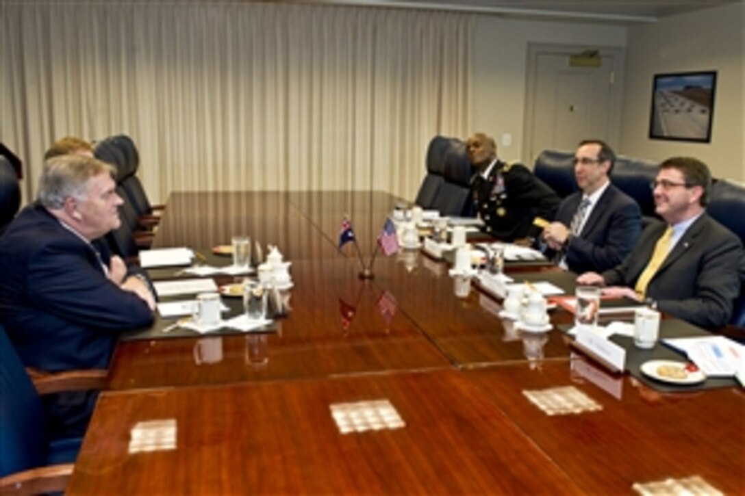 Deputy Defense Secretary Ashton B. Carter meets with Kim Beazley, Australian ambassador to the United States, at the Pentagon, March 8, 2012.