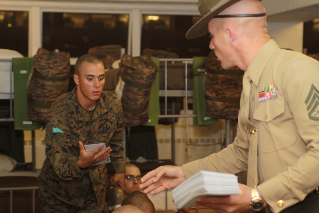 Staff Sgt. Robert Griffith, senior drill instructor, Company K, 3rd Recruit Training Battalion, passes out letters to platoon 3226 during mail call March 8 aboard Marine Corps Recruit Depot San Diego. During 12 weeks of recruit training aboard the depot, recruits rely on letters from family and friends for motivation to push through each training day.