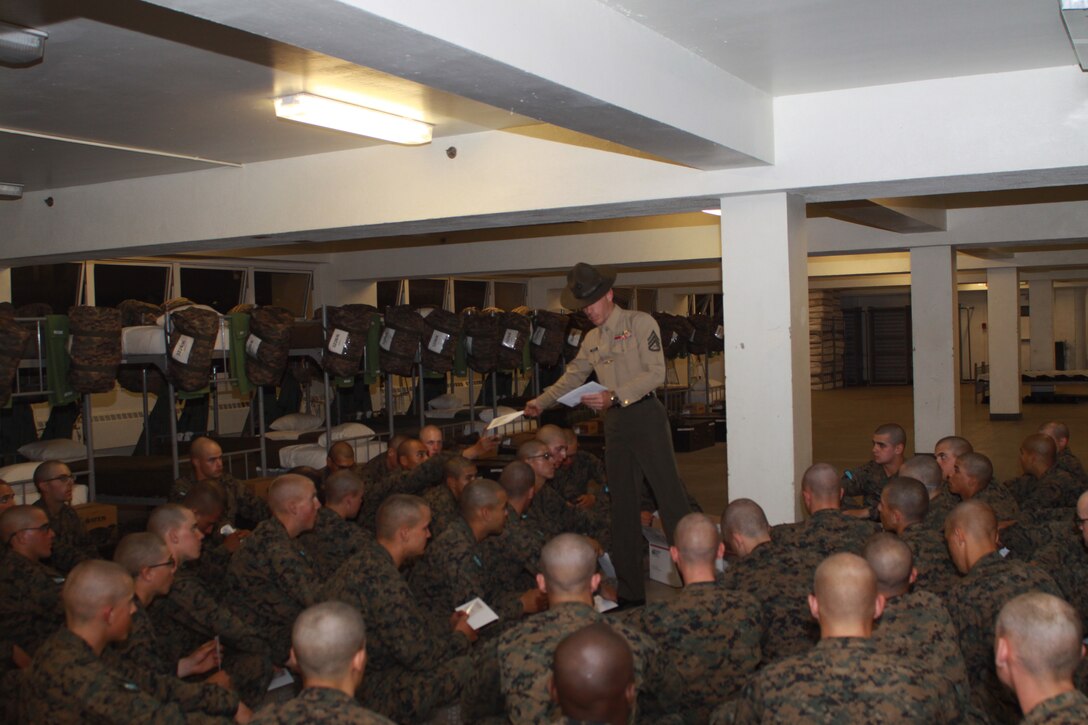 Staff Sgt. Robert Griffith, senior drill instructor, Company K, 3rd Recruit Training Battalion, passes out letters to platoon 3226 during mail call March 8 aboard Marine Corps Recruit Depot San Diego. The senior drill instructor holds a father figure role to recruits while they are in training, so Griffith makes sure he's always the one to pass out his platoon's mail.