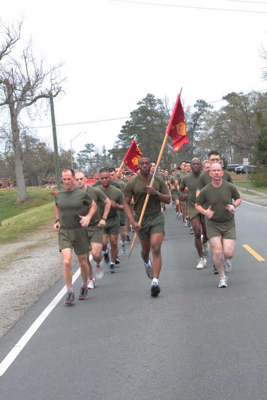 Marines and sailors with Headquarters Battalion, 2nd Marine Division, begin a two-mile run aboard Marine Corps Base Camp Lejeune, March 9. The battalion conducted a six-mile conditioning hike prior to the run. According to the battalion's letter of instruction, the hike and run were meant to reinforce the importance of combat fitness conditioning. (U.S. Marine Corps photograph by Sgt. Bryan A. Peterson)