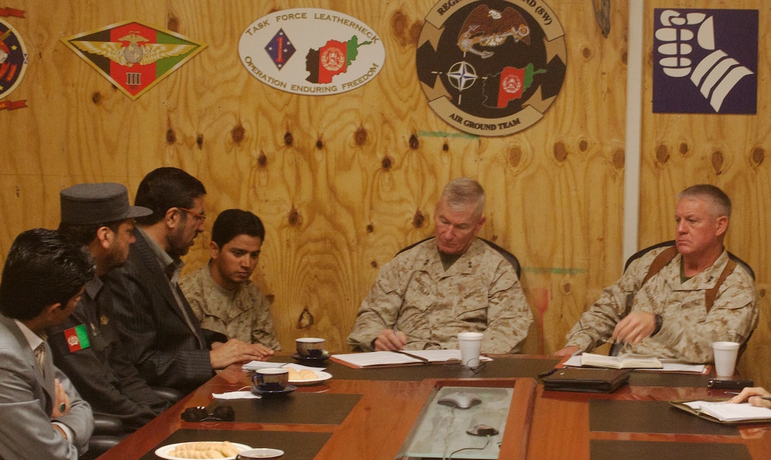 Major Gen. John A. Toolan, the commanding general for RC (SW), and Maj. Gen. Charles M. Gurganus, who is assuming command of RC (SW), speak with Qasim Khydri, the deputy governor of Nimruz province, during a key leader engagement meeting, March 9. Topics discussed during the meeting included the governance, security and developmental successes of Nimruz within the last couple of years since International Security Assistance Forces started to put an invested interest in the region.