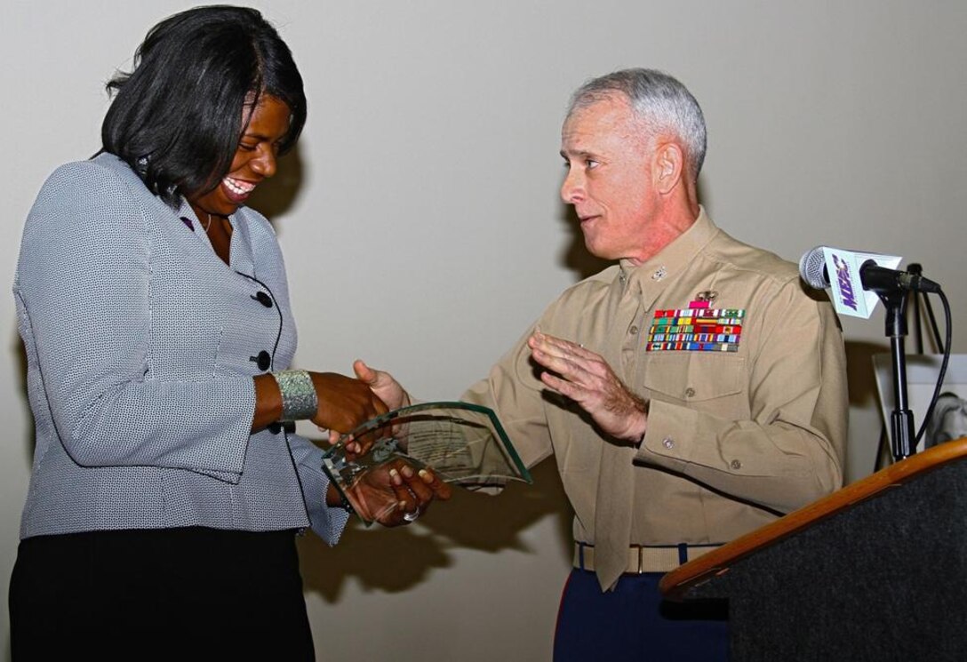 Alisha “Tuff” Hill, a graduate and former basketball player from Howard University in Washington, D.C., accepts the United States Marine Corps Excellence in Leadership Award at the 2012 Mid-Eastern Athletic Conference Hall of Fame Awards Brunch in Winston-Salem, N.C., March 9.  Colonel Rickey L. Grabowski, chief of staff, Eastern Recruiting Region, presented the award which is endorsed by the Commandant of the Marine Corps and given to individuals who exhibit Marine Corps values in their daily lives and careers.