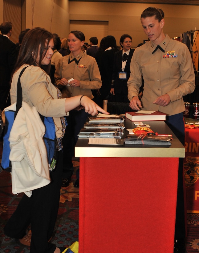 Megan Davis (left), a student at Lewis University in Romeoville, Ill. inquires about opportunities in aviation in the Marine Corps at the 23rd Annual Women in Aviation International Conference held March 8-10, 2012, in Dallas. Officer selection officers said that the booth received several hundred of the conference’s 3,350 attendees, including high school students, college, workers for major airlines, surviving members of the Women Airforce Service Pilots of World War II, and other service members in aviation.