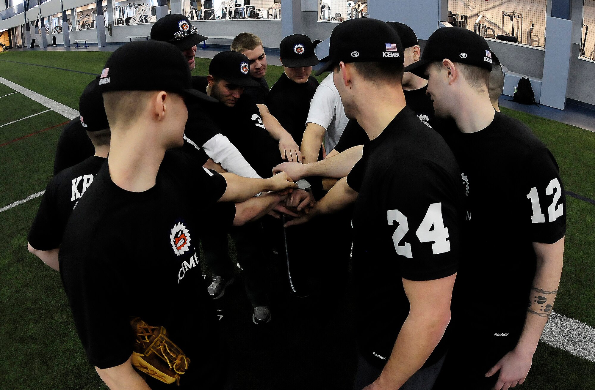 The Eielson baseball team huddles together after completing a practice session at Baker Field House March 3, 2012, Eielson Air Force Base, Alaska. Members encourage each other to push themselves in order to stay in shape during the off-season. (U.S. Air Force photo/Airman 1st Class Zachary Perras)