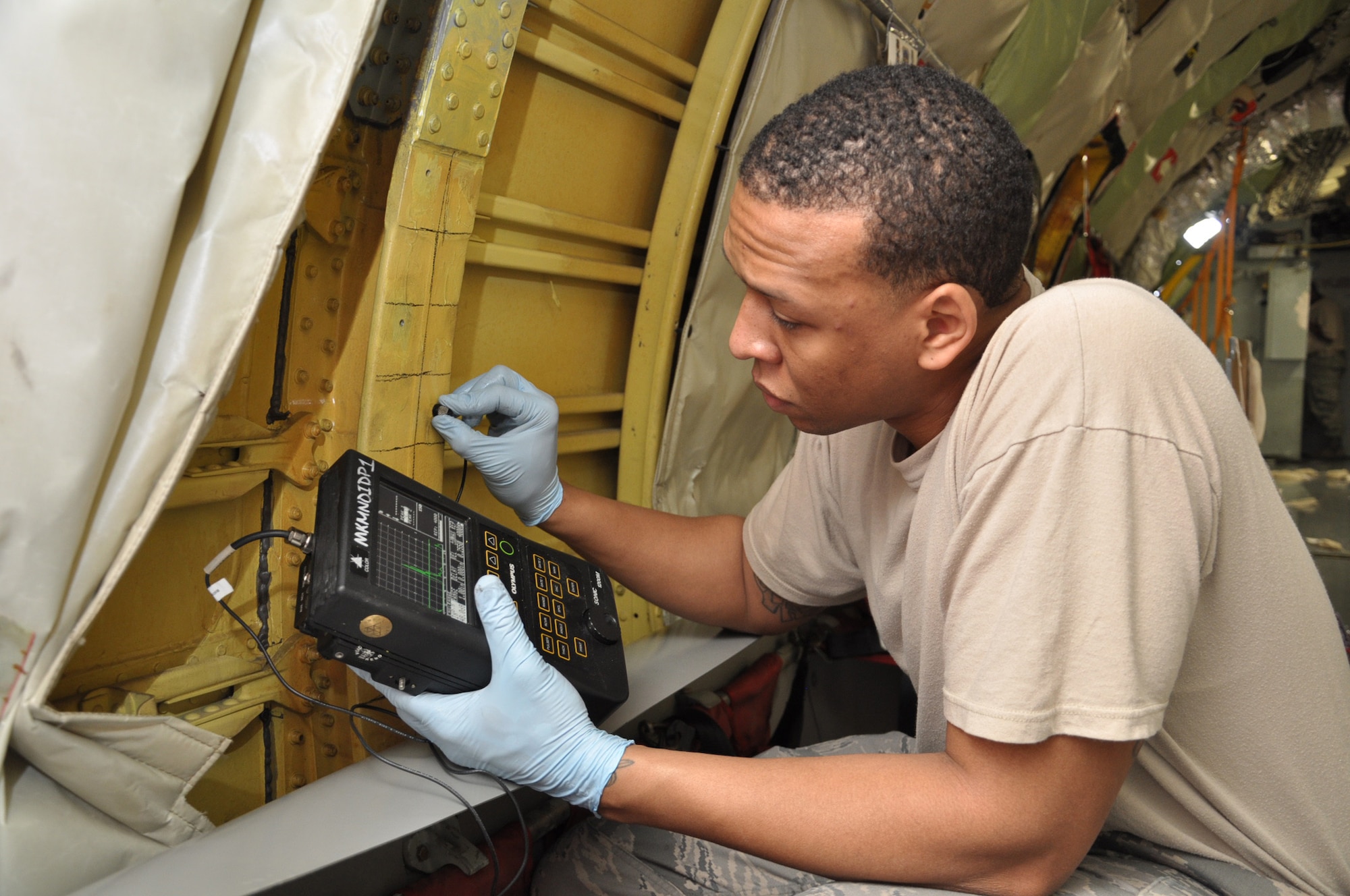 Staff Sgt. Bryan Tyler, 22nd Maintenance Squadron, uses an an ultrasonic transducer to search for defects in the bulkhead of a KC-135 Stratotanker. (Air Force photo by Tech. Sgt. Brannen Parrish)