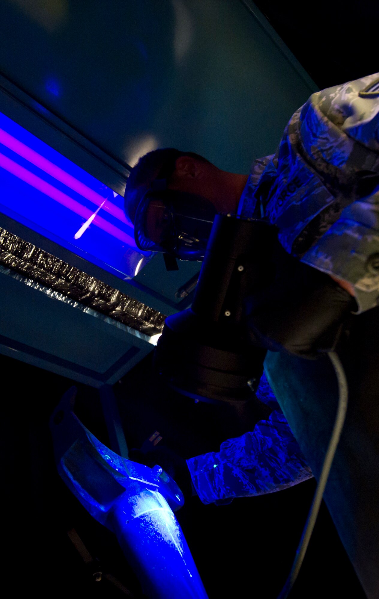 Tech. Sgt. Mark Teusch, NCOIC, Nondestructive Inspections, 22nd Maintenance Squadron, uses a blacklight to find cracks in an aircraft part. (Air Force photo by Airman 1st Class Armondo Schwier-Morales) 