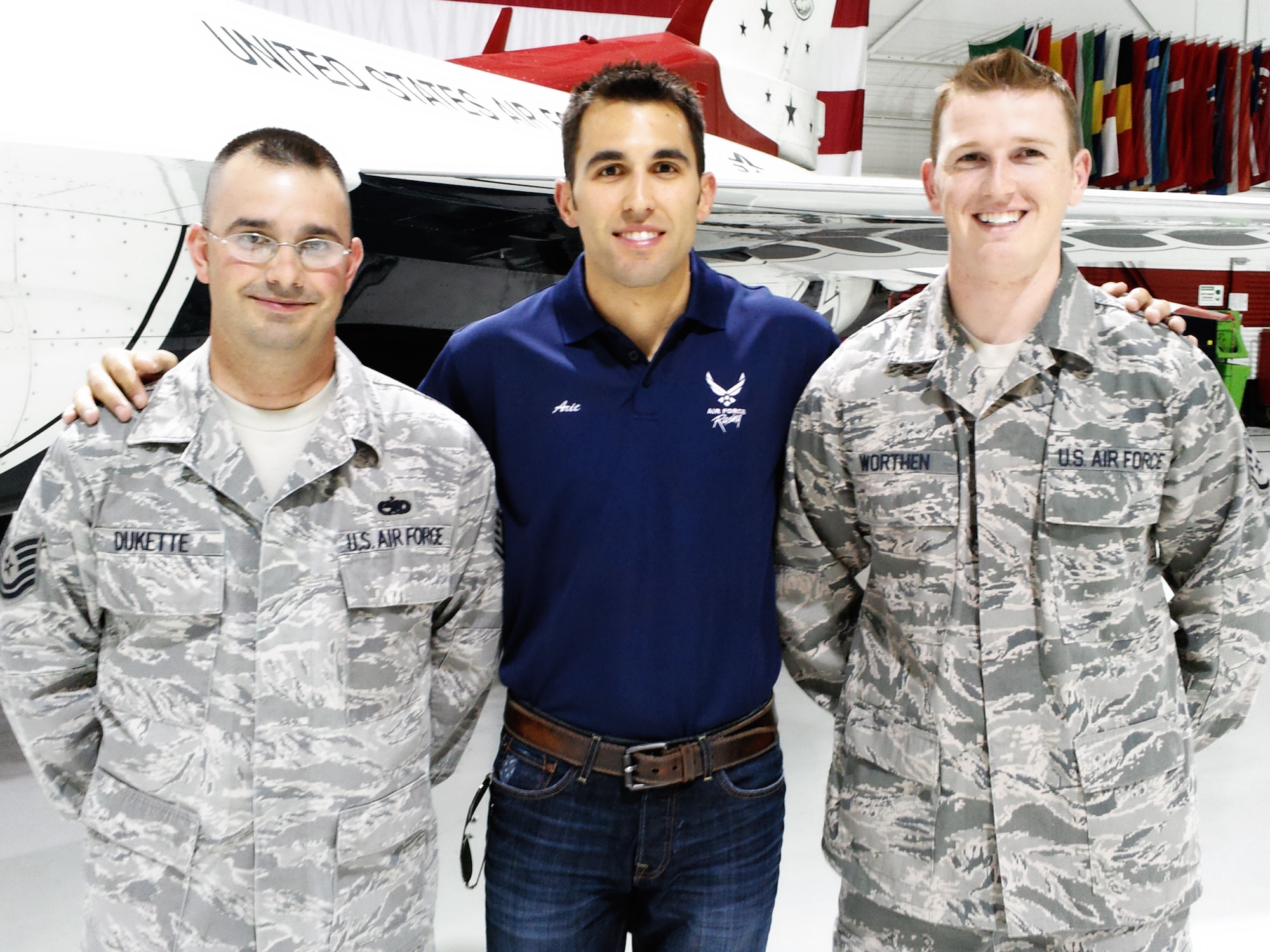 Aric Almirola, driver of the Air Force-sponsored No. 43 car, greets two new members of the U.S. Air Force Thunderbirds Air Demonstration Squadron in the Thunderbirds hangar March 8, 2012. Almirola was in town to compete in the Kobalt Tools 400 NASCAR race at Las Vegas Motor Speedway March 11.
