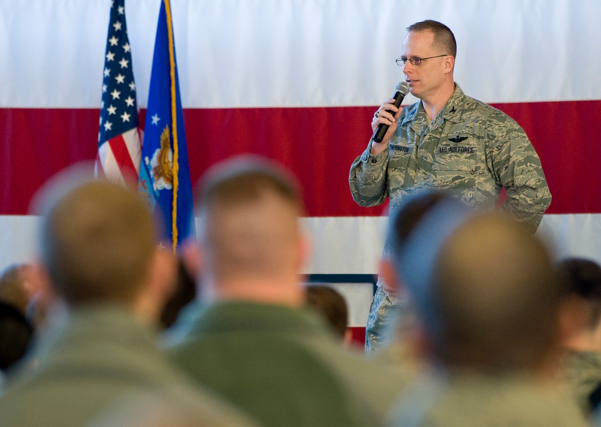 Col. Mark Weatherington, 28th Bomb Wing commander, addresses the Airmen during a commander’s call in the Pride Hangar at Ellsworth Air Force Base, S.D., March 8, 2012. Weatherington commended the Airmen for their accomplishments during the last Operational Readiness Exercise and discussed a variety of topics ranging from safety to a new responsible drinking educational campaign called 0-1-3. (U.S. Air Force photo by Staff Sgt. Marc I. Lane/Released)