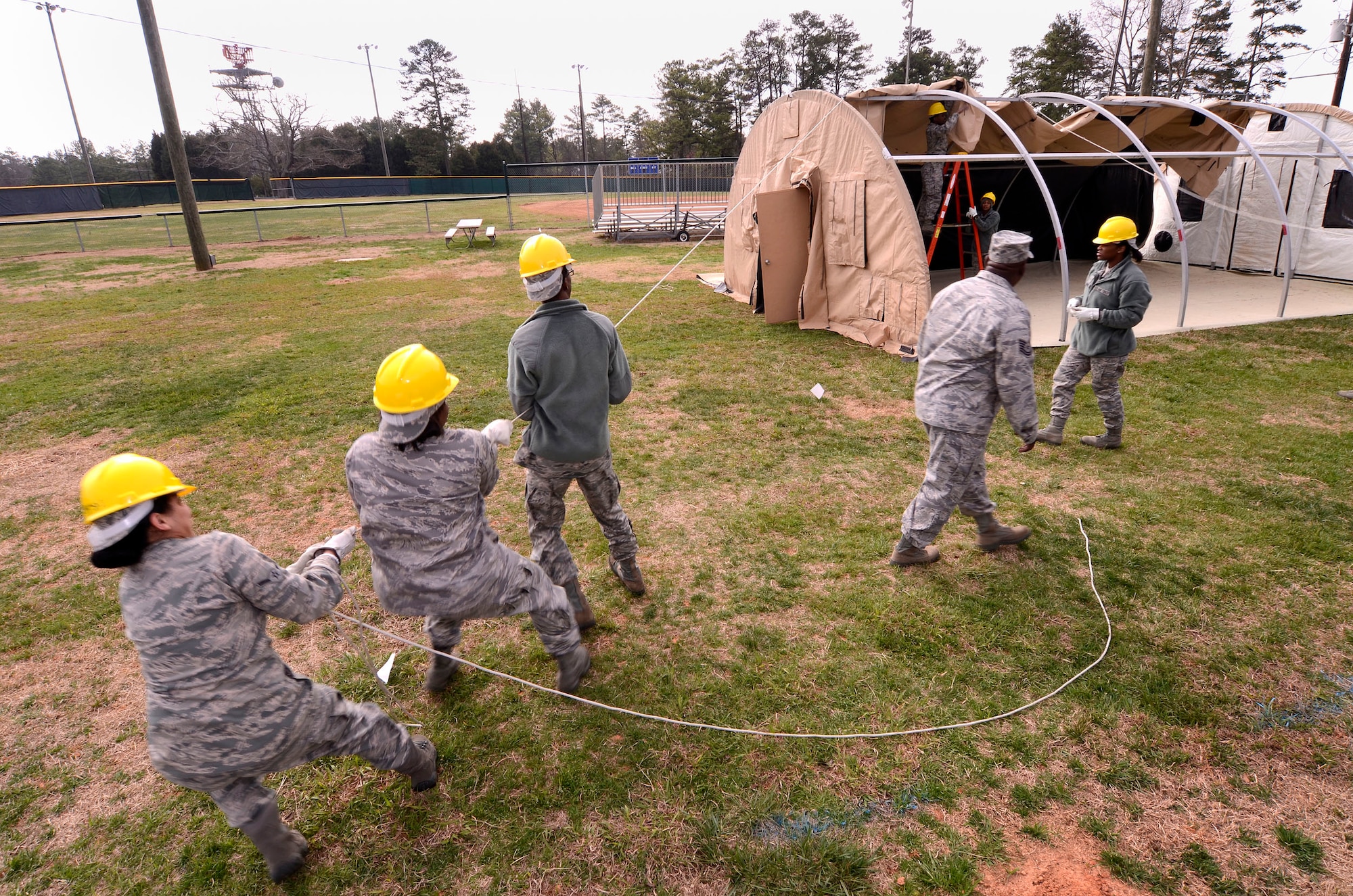 94th Force Support Squadron personnel pull the main canvas panel over the frame of the Alaska personnel shelter being setup at Dobbins Air Reserve Base, Ga, Mar. 7. Reservist with the 94th FSS performed and received annual tour training throughout the week in order to stay proficient or upgrade their specialized Air Force skills. (U.S. Air Force photo/ Brad Fallin)