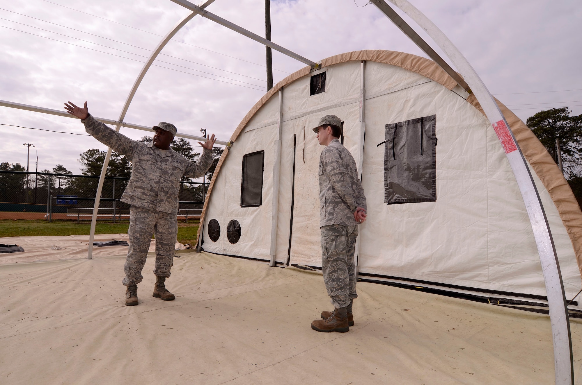 Tech. Sgt. Michael Todd, 94th Force Support Squadron readiness manager, explains the sequence of assembly for the Alaska personnel shelter to Lt. Col. David Dick, Commander of the 94th Force Support Squadron at Dobbins Air Reserve Base, Ga, Mar. 7. Reservist with the 94th FSS performed and received annual tour training throughout the week in order to stay proficient or upgrade their specialized Air Force skills. (U.S. Air Force photo/ Brad Fallin)