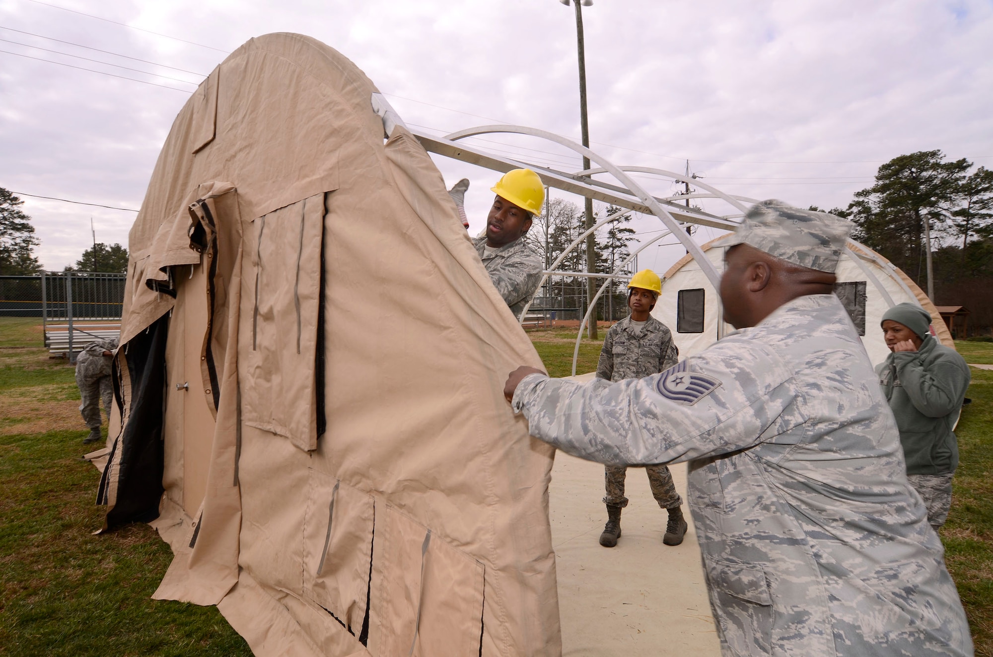 Tech. Sgt. Michael Todd, 94th Force Support Squadron readiness manager, pulls a canvas tight as Airman Joseph Hunter anchors it to the frame of the Alaska personnel shelter at Dobbins Air Reserve Base, Ga, Mar. 7. Reservist with the 94th FSS performed and received annual tour training throughout the week in order to stay proficient or upgrade their specialized Air Force skills. (U.S. Air Force photo/ Brad Fallin)