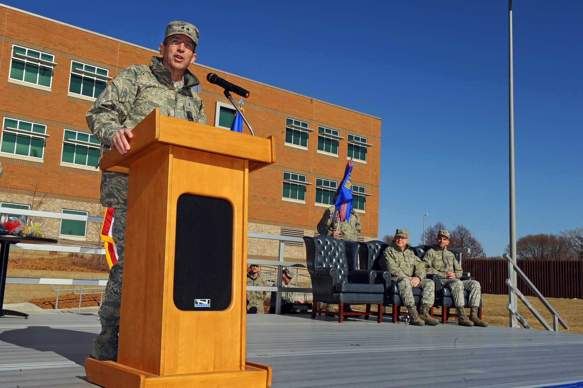 OFFUTT AIR FORCE BASE, Neb. -- Maj. Gen. Brett T. Williams, the Air Force's director of operations and deputy chief of staff for operations, plans and requirements, addresses attendees at the Air Force Weather Agency change of command ceremony here as Col. Robert Russell, outgoing AFWA commander, and Col. Louis Zuccarello, incoming AFWA commander, look on March 9. Zuccarello takes over after serving as vice commander since February 2011.