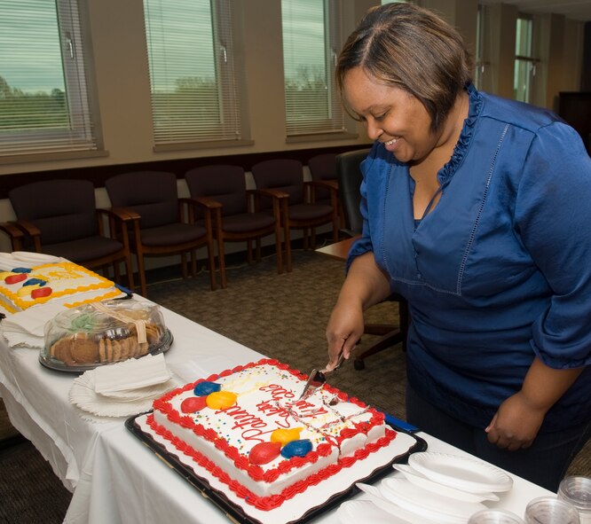 Karla Duncan, 2nd Medical Group patient safety program manager, cuts a cake in celebration of Patient Safety Awareness Week on Barksdale Air Force Base, La., March 9. The theme for this year, "Be Aware for Safe Care", called for health care professionals to be aware of ongoing efforts to improve patient safety and take part in sharing that information with patients and their families. (U.S. Air Force photo/Senior Airman Kristin High)(RELEASED)