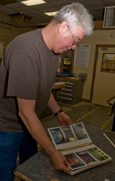 Don Roberts, 2nd Force Support Squadron Wood Craft Center assistant manager, looks at previously made coin racks for ideas on Barksdale Air Force Base, La., March 9. Roberts helps build five to eight shadow boxes per week. Usually created for retirements, the wood shop offers custom built shadow boxes as well as coin racks, signs, bookshelves and anything built from wood. (U.S. Air Force photo/Senior Airman Kristin High)(RELEASED) 