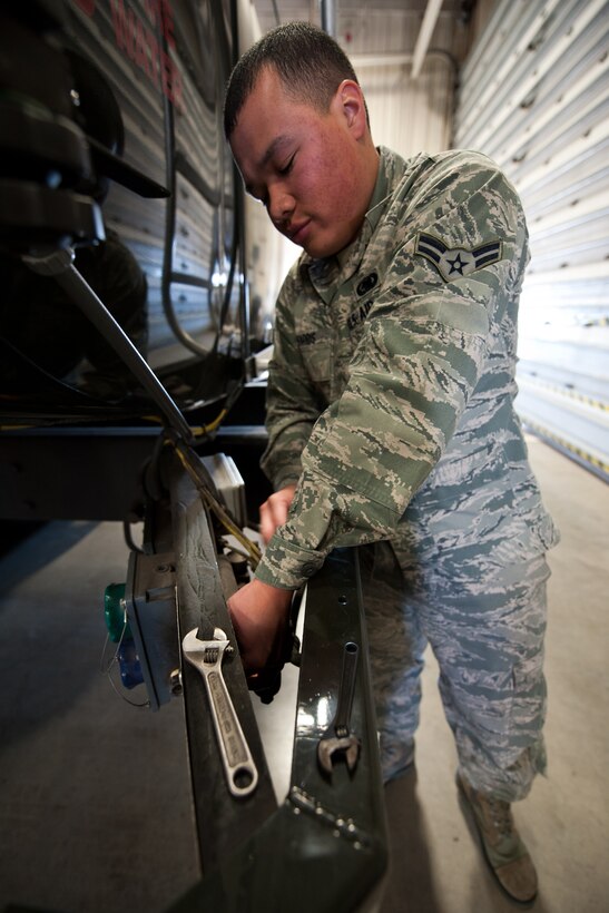 Airman 1st Class Ryan Harris, 28th Logistics Readiness Squadron refueling maintenance technician, replaces a tank level override button on a fuel truck during maintenance at Ellsworth Air Force Base, S.D., March 8, 2012. The override button allows personnel to bypass the automatic shutoff probe called the high-high probe if the fuel truck is full. (U.S. Air Force photo by Airman Alystria Maurer/Released)