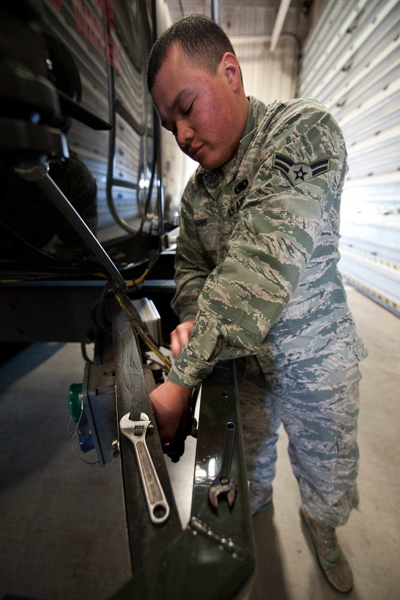 Airman 1st Class Ryan Harris, 28th Logistics Readiness Squadron refueling maintenance technician, replaces a tank level override button on a fuel truck during maintenance at Ellsworth Air Force Base, S.D., March 8, 2012. The override button allows personnel to bypass the automatic shutoff probe called the high-high probe if the fuel truck is full. (U.S. Air Force photo by Airman Alystria Maurer/Released)