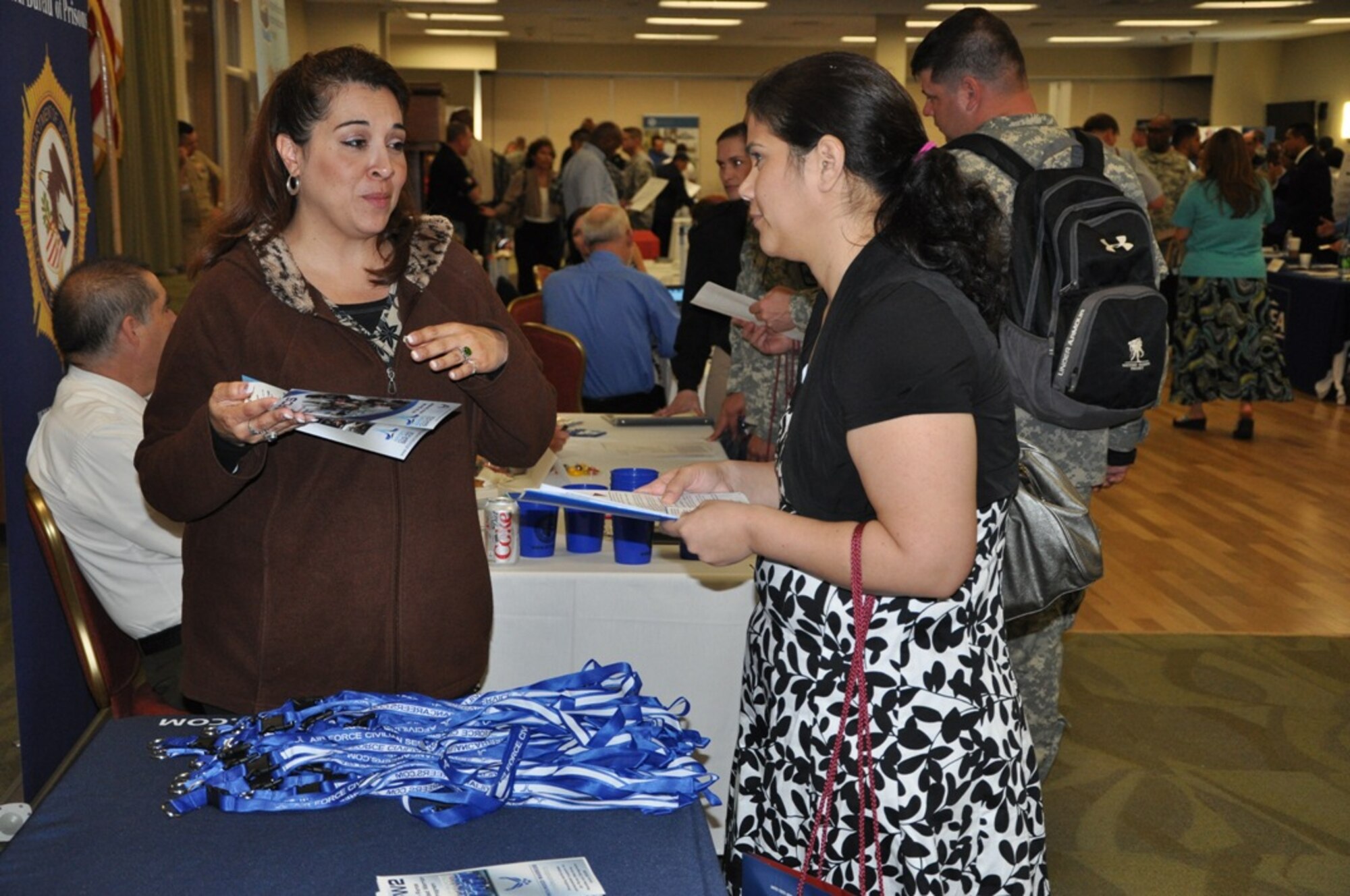 Amy Ruiz, Air Force Personnel Center human resources specialist, provides information about Air Force civilian careers to an attendee during the Hiring Heroes Career Fair at Joint Base San Antonio-Fort Sam Houston March 6. The fair offers job opportunities for veterans and their family members and face-to-face meetings with recruiters from DoD, other federal agencies and the private sector about future employment in civilian career fields. For more information about how to become an Air Force civilian, visit www.afciviliancareers.com. (Courtesy photo) 
