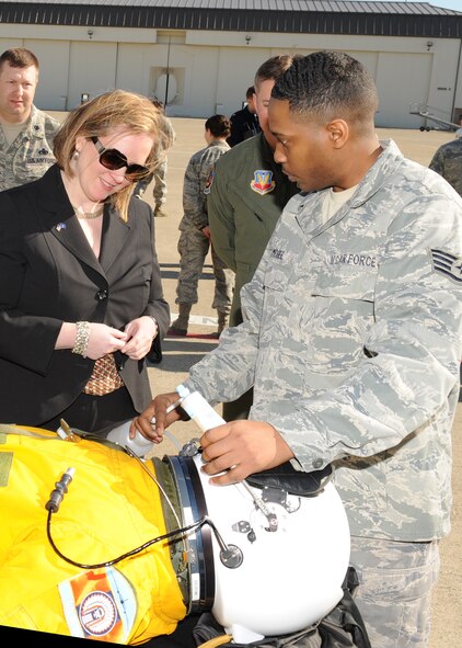U.S. Air Force Staff Sgt. Kentonis McGee, 9th Physiological Support Squadronsuit technician, explains to Under Secretary of the Air Force Erin Conaton how U-2 pilots drink and eat during long flights. Conaton visited Beale Air Force Base, Calif., March 7, 2012, to learn more about the base's continuing intelligence, surveillance and reconnaissance mission. (U.S. Air Force photo/John Schwab/Released)