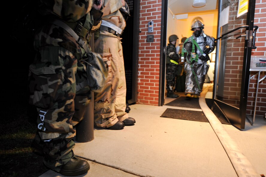 A 4th Civil Engineer Squadron fire emergency services flight firefighter leaves the 4th Fighter Wing Headquarters building  after responding to a fire after a simulated attack on the Command Post during a phase II Operational Readiness Exercise on Seymour Johnson Air Force Base, N.C., Mar. 8, 2012. The 4th Fighter Wing will conduct exercises throughout the year in preparation for the 2013 Operational Readiness Inspection. (U.S. Air Force photo/Tech. Sgt. Colette M. Graham/Released)