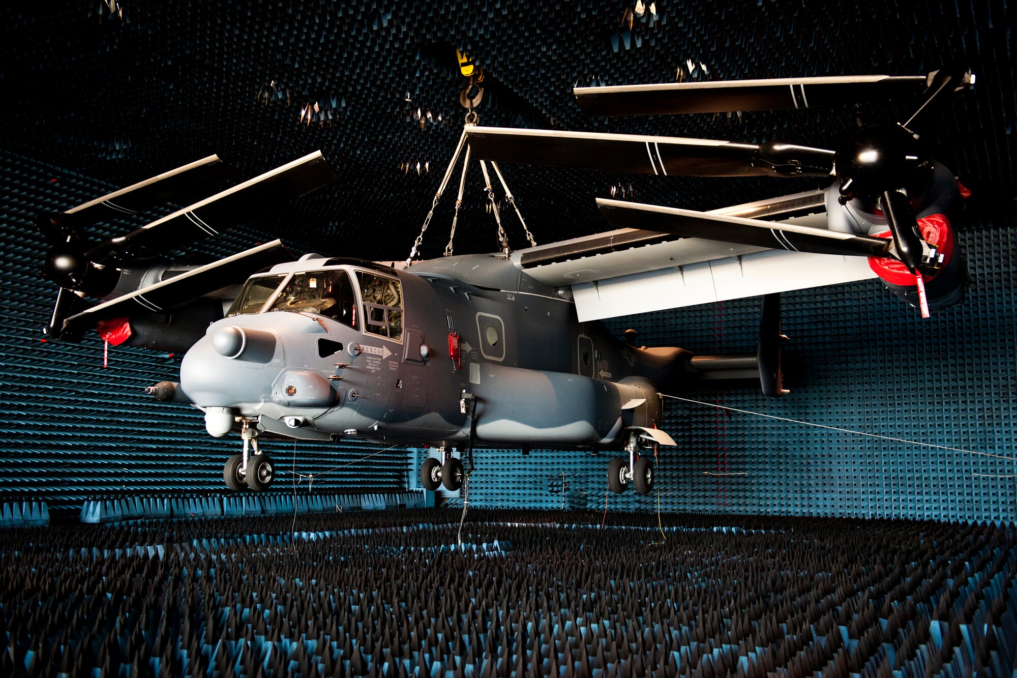 A CV-22 Osprey, flown by the 8th Special Operations Squadron, hangs in the anechoic chamber at the Joint Preflight Integration of Munitions and Electronic Systems hangar March 6 at Eglin Air Force Base, Fla.  The Osprey is currently in the chamber for approximately four weeks to test upgraded electronic warfare systems.  The J-PRIMES anechoic chamber is a room designed to stop internal reflections of electromagnetic waves, as well as insulate from exterior sources of electromagnetic noise.  J-PRIMES provides this environment to facilitate testing air-to-air and air-to-surface munitions and electronics systems on full-scale aircraft and land vehicles
prior to open air testing. (U.S. Air Force photo/Samuel King Jr.)