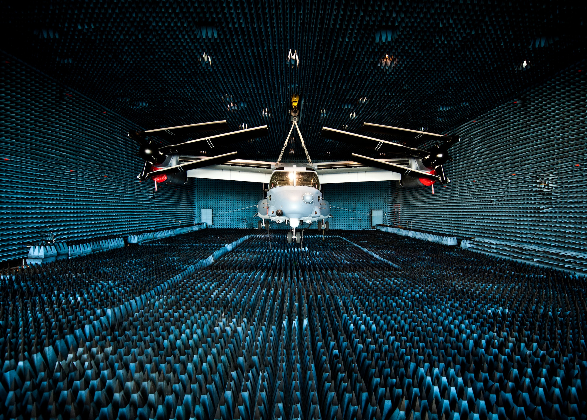 A CV-22 Osprey, flown by the 8th Special Operations Squadron, hangs in the anechoic chamber at the Joint Preflight Integration of Munitions and Electronic Systems hangar March 6 at Eglin Air Force Base, Fla.  The Osprey is currently in the chamber for approximately four weeks to test upgraded electronic warfare systems.  The J-PRIMES anechoic chamber is a room designed to stop internal reflections of electromagnetic waves, as well as insulate from exterior sources of electromagnetic noise.  J-PRIMES provides this environment to facilitate testing air-to-air and air-to-surface munitions and electronics systems on full-scale aircraft and land vehicles
prior to open air testing. (U.S. Air Force photo/Samuel King Jr.)