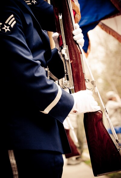 A member of the flag detail holds the rifle out during the “present arms” command at the Honor Guard graduation ceremony at Eglin Air Force Base, Fla.  Approximately 16 new Airmen graduated from the 80-plus-hour course.  Prior to the graduation, the Airmen perform a full honors, military funeral to include flag detail, the 21-gun salute, pall bearers and bugler for friends, family and unit commanders.  (U.S. Air Force photo/Samuel King Jr.)