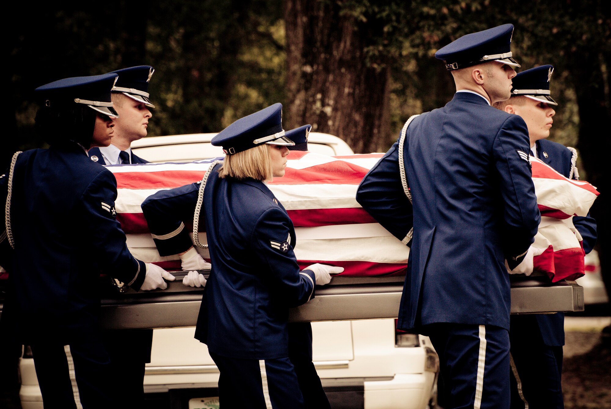 Members of the Eglin Honor Guard carry the flag-draped casket during a mock funeral as part of the honor guard graduation. Approximately 16 new Airmen graduated from the 80-plus-hour course.  Prior to the graduation, the Airmen perform a full honors, military funeral to include flag detail, the 21-gun salute, pall bearers and bugler for friends, family and unit commanders.  (U.S. Air Force photo/Samuel King Jr.)