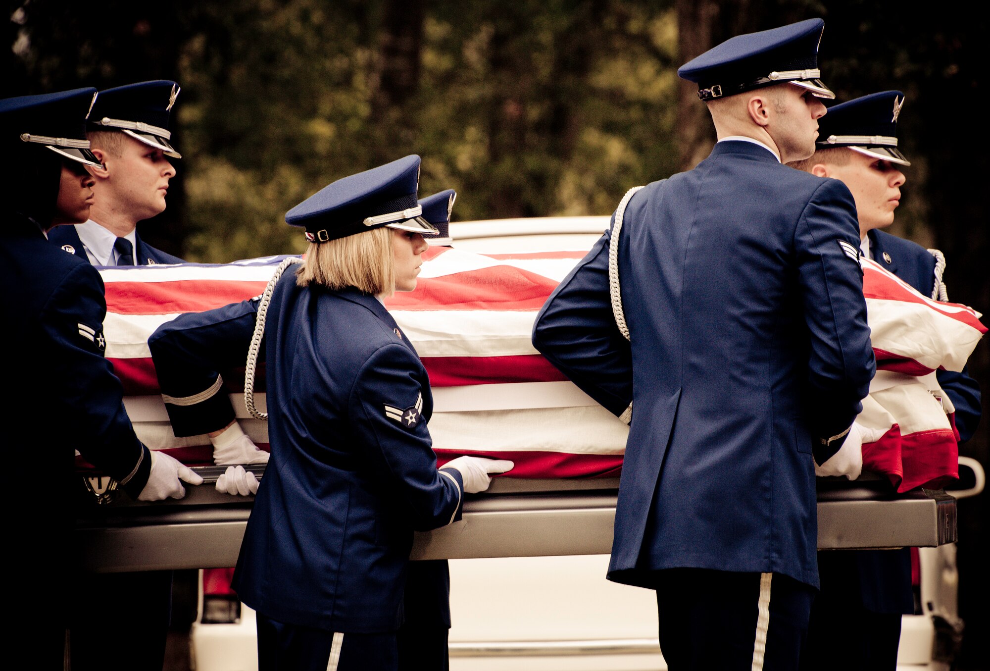 Members of the Eglin Honor Guard carry the flag-draped casket during a mock funeral as part of the honor guard graduation. Approximately 16 new Airmen graduated from the 80-plus-hour course.  Prior to the graduation, the Airmen perform a full honors, military funeral to include flag detail, the 21-gun salute, pall bearers and bugler for friends, family and unit commanders.  (U.S. Air Force photo/Samuel King Jr.)