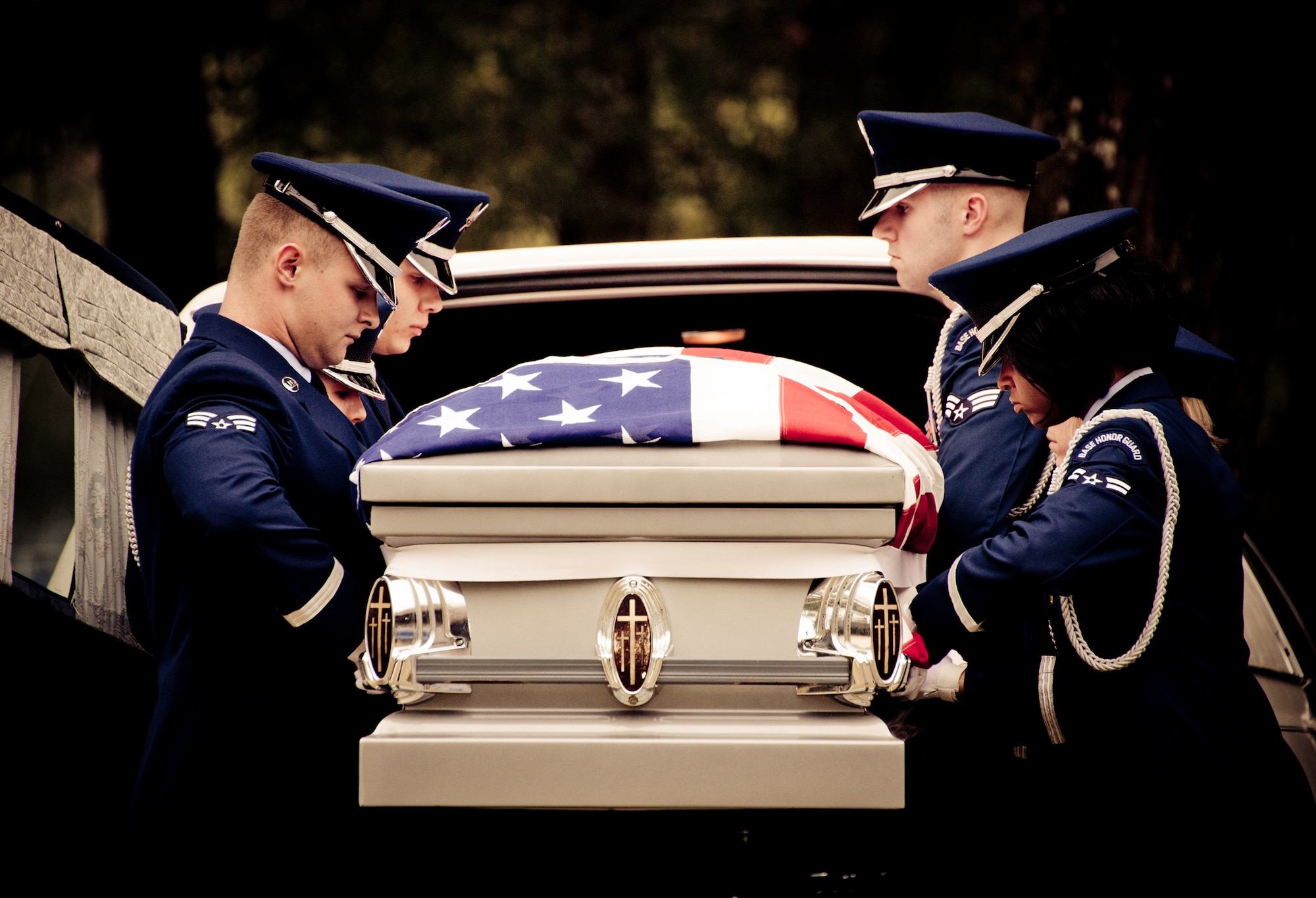 Members of the Eglin Honor Guard remove the flag-draped casket from the hearse during a mock funeral as part of the honor guard graduation. Approximately 16 new Airmen graduated from the 80-plus-hour course.  Prior to the graduation, the Airmen perform a full honors, military funeral to include flag detail, the 21-gun salute, pall bearers and bugler for friends, family and unit commanders.  (U.S. Air Force photo/Samuel King Jr.)