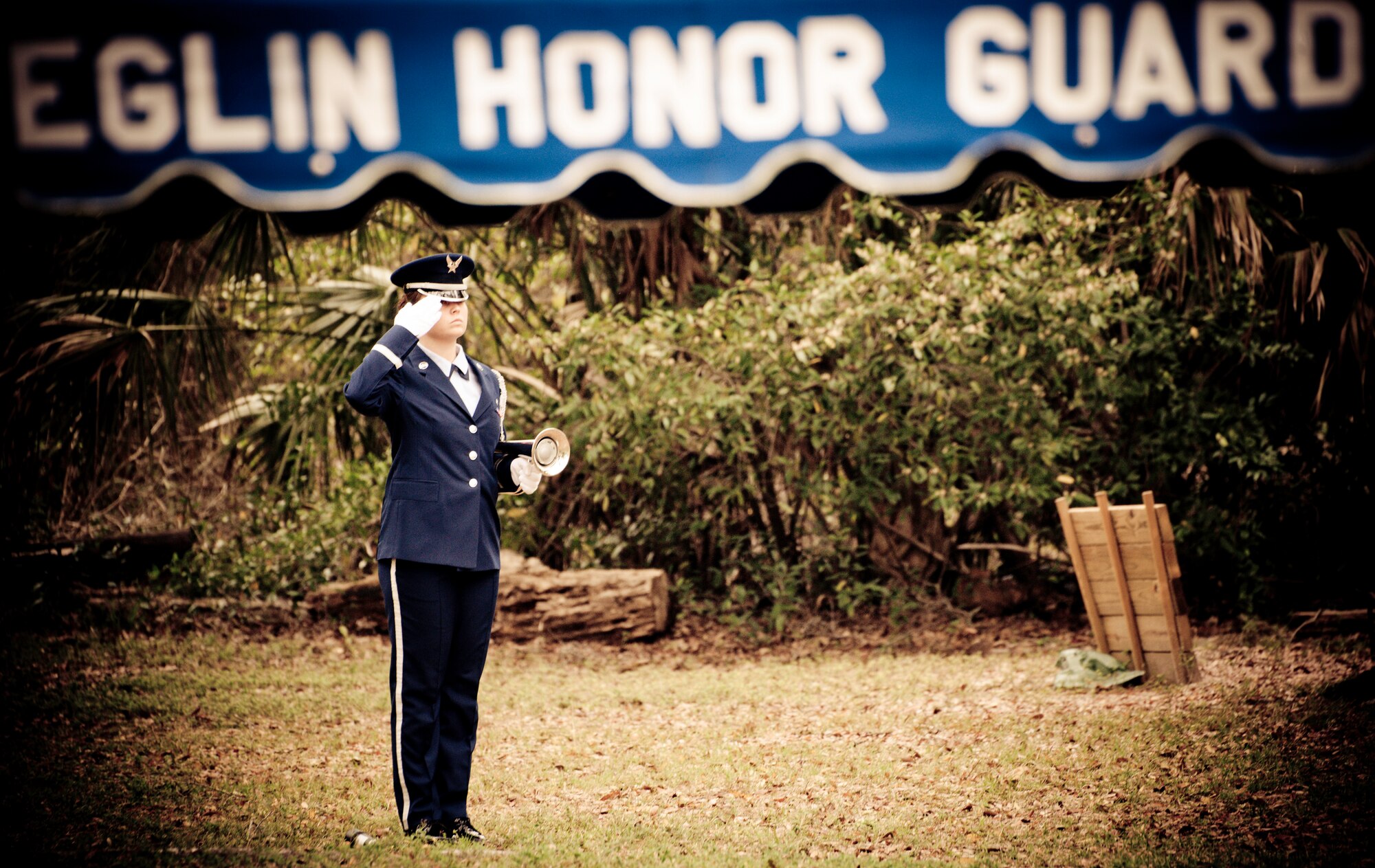 Airman 1st Class Brittany White, of the Eglin Honor Guard, salutes during a military funeral performance at the honor guard graduation at Eglin Air Force Base, Fla.  Approximately 16 new Airmen graduated from the 80-plus-hour course.  Prior to the graduation, the Airmen perform a full honors, military funeral to include flag detail, the 21-gun salute, pall bearers and bugler for friends, family and unit commanders.  (U.S. Air Force photo/Samuel King Jr.)