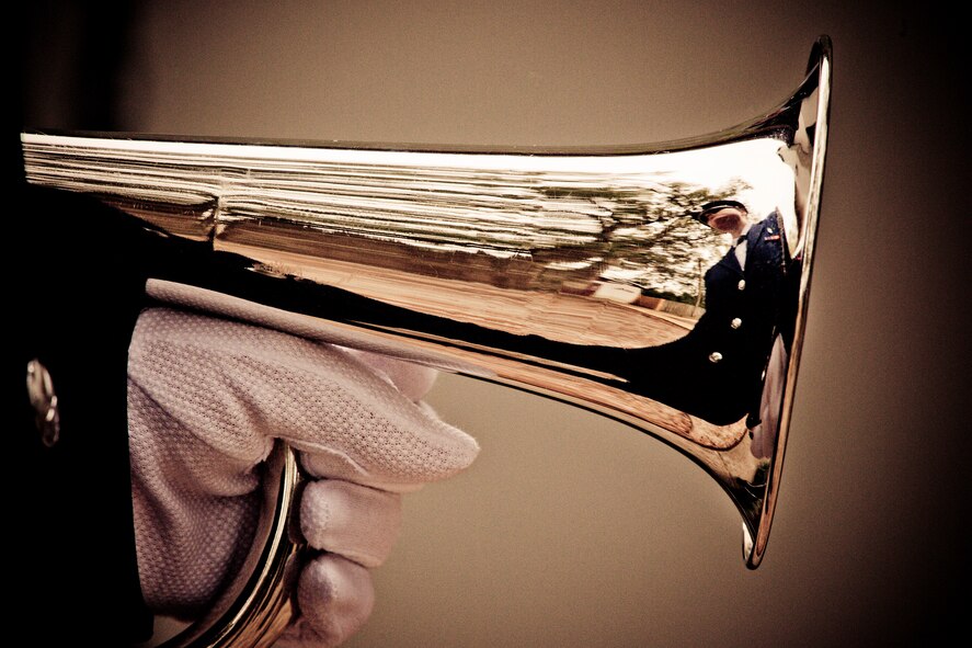Airman 1st Class Brittany White, of the Eglin Honor Guard, holds her bugle prior to a military funeral performance at the honor guard graduation at Eglin Air Force Base, Fla.  Approximately 16 new Airmen graduated from the 80-plus-hour course.  Prior to the graduation, the Airmen perform a full honors, military funeral to include flag detail, the 21-gun salute, pall bearers and bugler for friends, family and unit commanders.  (U.S. Air Force photo/Samuel King Jr.)