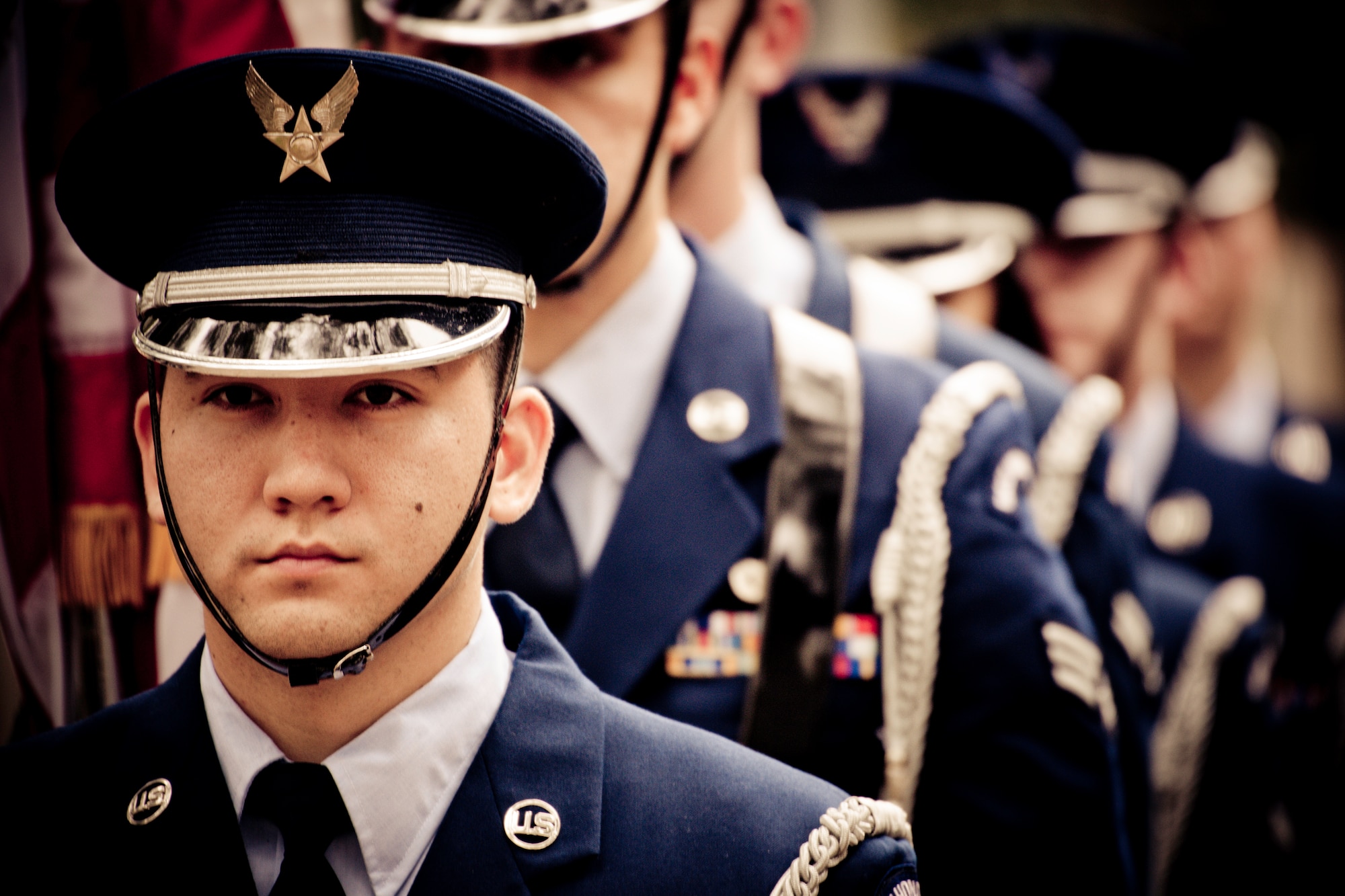 Airman 1st Class Eric Esser and other Airmen stand ready to present the colors at the honor guard graduation ceremony at Eglin Air Force Base, Fla.  Approximately 16 new Airmen graduated from the 80-plus-hour course.  Prior to the graduation, the Airmen perform a full honors, military funeral to include flag detail, the 21-gun salute, pall bearers and bugler for friends, family and unit commanders.  (U.S. Air Force photo/Samuel King Jr.)