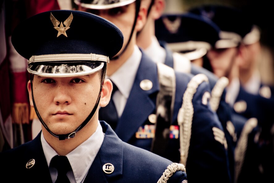Airman 1st Class Eric Esser and other Airmen stand ready to present the colors at the honor guard graduation ceremony at Eglin Air Force Base, Fla.  Approximately 16 new Airmen graduated from the 80-plus-hour course.  Prior to the graduation, the Airmen perform a full honors, military funeral to include flag detail, the 21-gun salute, pall bearers and bugler for friends, family and unit commanders.  (U.S. Air Force photo/Samuel King Jr.)