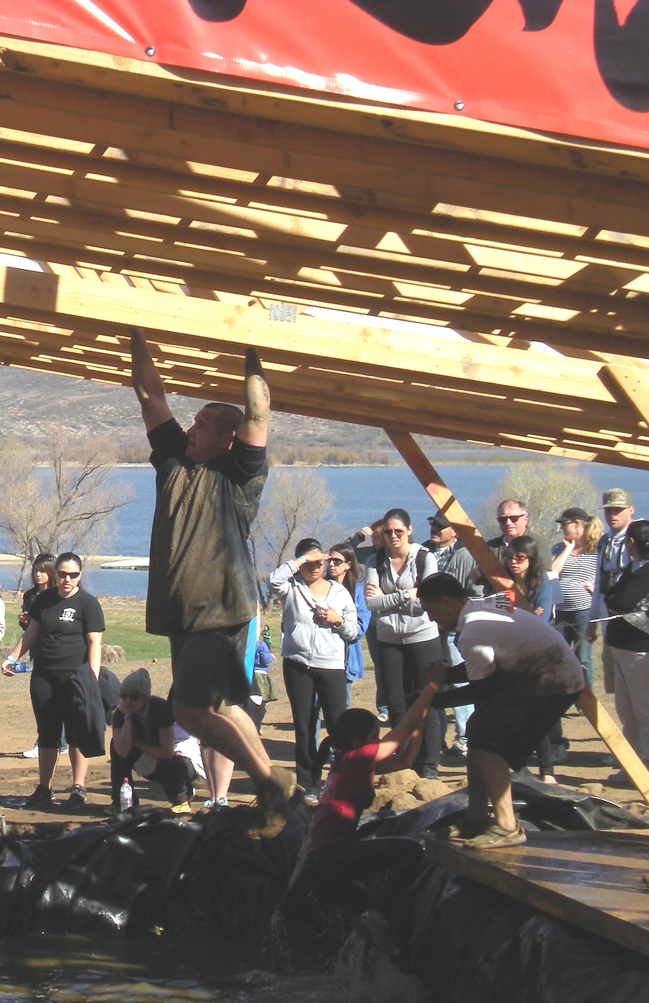 (Left) Maj. Andrew Hosler, Detachment 1, 53rd Computer Support Squadron commander, angles his way across greased monkey bars and a pool of freezing water in the Tough Mudder challenge, held Feb. 25 in southern California. (courtesy photo)