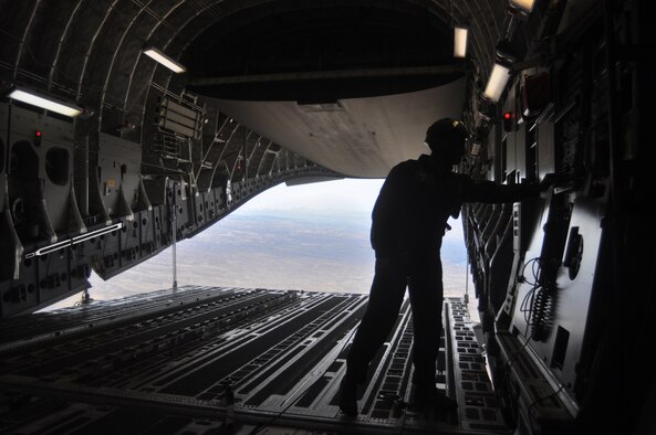 Staff Sgt. Todd Tichawa, 62nd Operations Support Squadron, performs last-minute checks before the first continental C-17 Globemaster III JPADS airdrop March 8, 2012, at Joint Base Lewis-McChord, Wash. (U.S. Air Force photo/Airman 1st Class Leah Young)