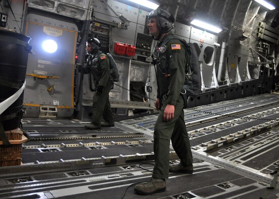 Staff Sgts. Kevin Johnson, left, 8th Airlift Squadron, and Staff Sgt. Todd Tichawa, left, 62nd Operations Support Squadron, prepare to open the doors before the first continental C-17 Globemaster III Joint Precision Airdrop System airdrop during routine training March 8, 2012, at Joint Base Lewis-McChord, Wash. While JPADS have been used in theater since 2006, the majority of aircrews haven’t had the opportunity to fine-tune their skills prior to executing this method during actual combat missions. (U.S. Air Force photo/Airman 1st Class Leah Young)