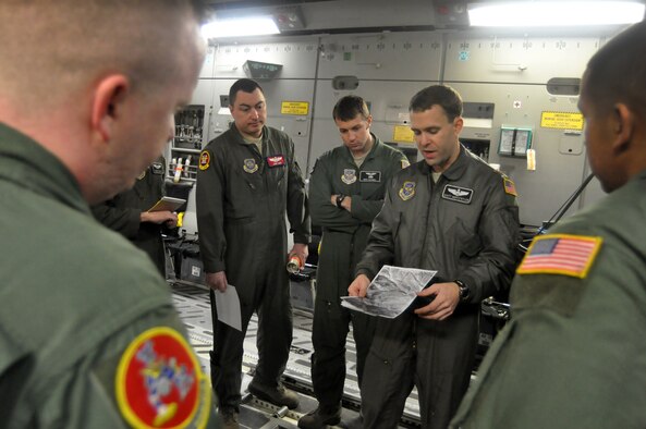 Maj. David Huffstetler, 62nd Operations Support Squadron, provides crewmembers with a mission briefing before the first continental C-17 Globemaster III Joint Precision Airdrop System airdrop March 8, 2012, at Joint Base Lewis-McChord, Wash. (U.S. Air Force photo/Airman 1st Class Leah Young)