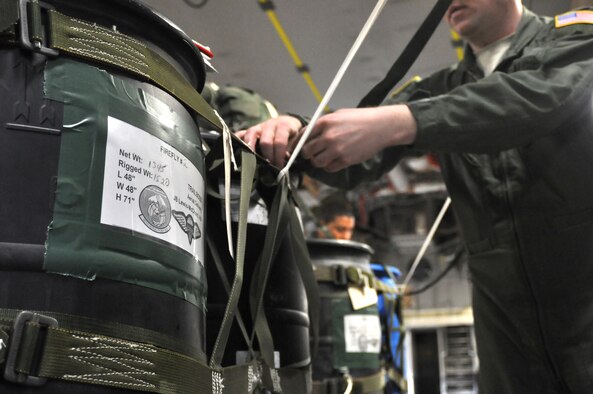 Staff Sgt. Todd Tichawa, 62nd Operations Support Squadron, secures cargo before the first continental C-17 Globemaster III Joint Precision Airdrop System March 8, 2012, at Joint Base Lewis-McChord, Wash. Two bundles equaling 2,900 pounds were dropped using JPADS at Yakima Training Center, Wash. (U.S. Air Force photo/Airman 1st Class Leah Young)