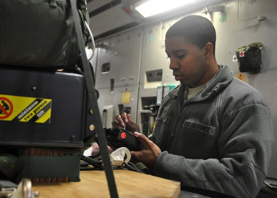 Senior Airman Trivone Curry, 62nd Operations Support Squadron combat communications specialist, inputs data into a Joint Precision Airdrop System, or JPADS, before the first continental C-17 Globemaster III JPADS airdrop during routine training March 8, 2012, at Joint Base Lewis-McChord, Wash. JPADS is an airdrop system that uses Global Positioning Satellite, steerable parachutes and an onboard computer to steer loads to a designated point of impact on a drop zone. (U.S. Air Force photo/Airman 1st Class Leah Young)